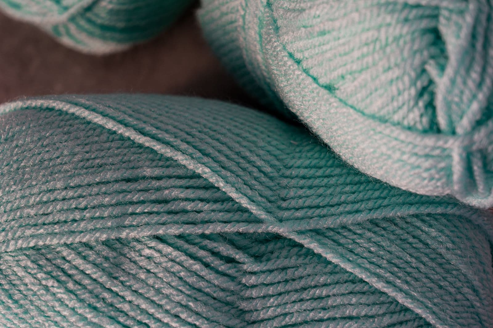 Close detail of teal yarn, the twist of the fibre visible