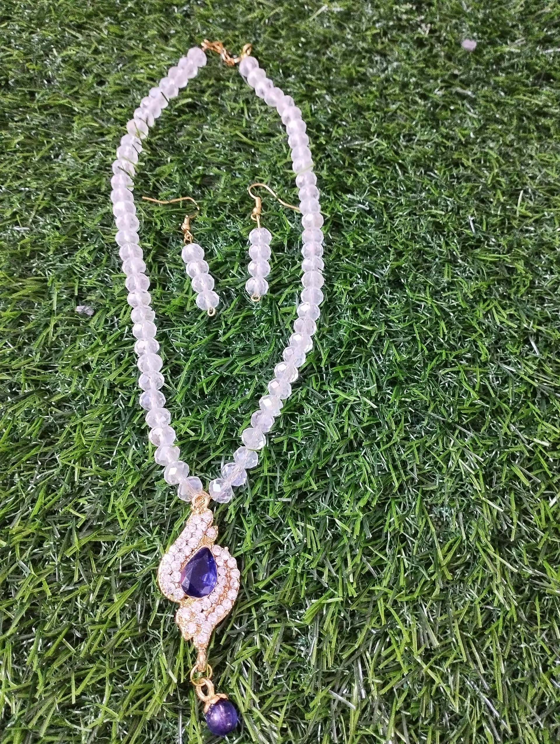 Necklace and earring set — pale pink with a violet stone