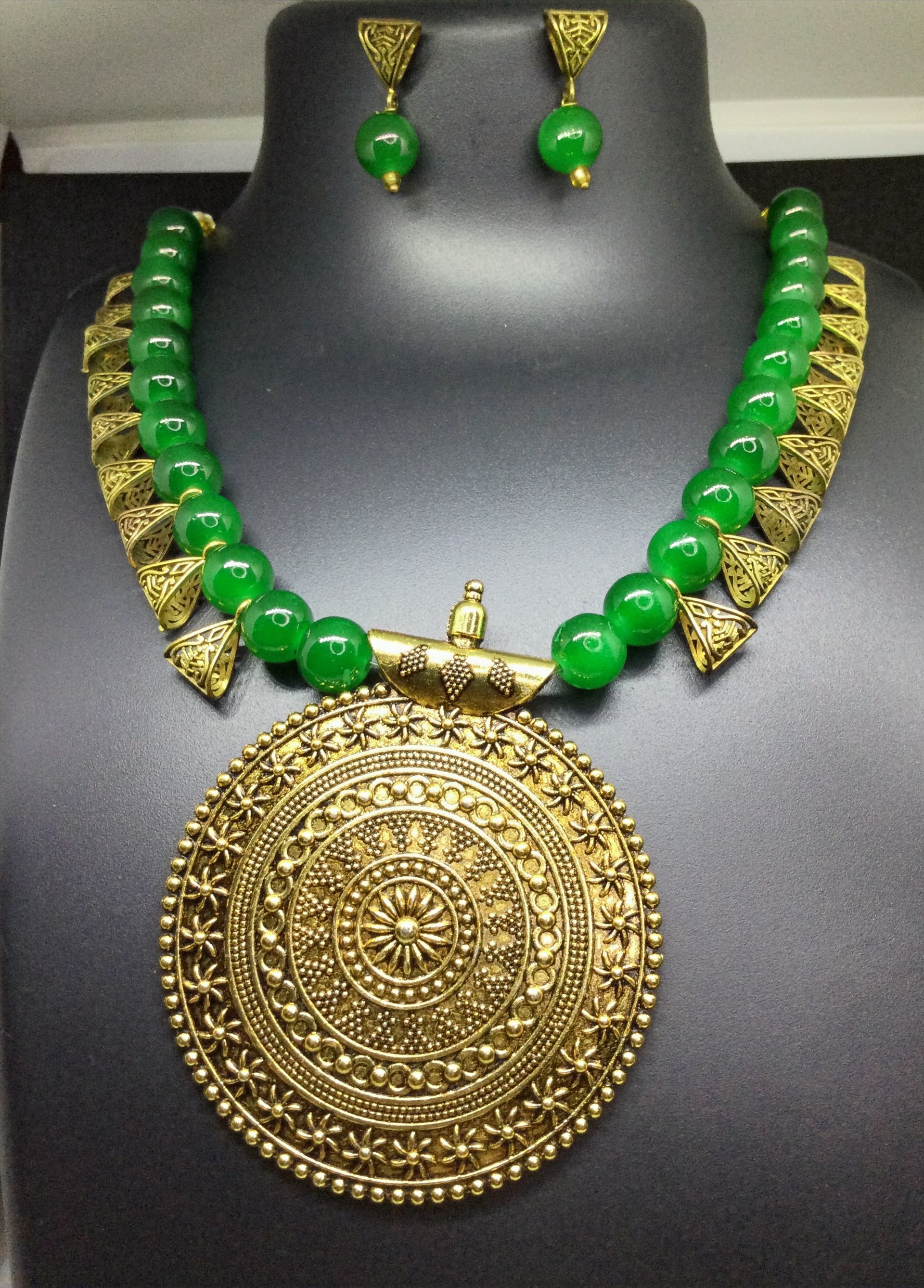 Necklace and earring set — emerald green with a brass medallion