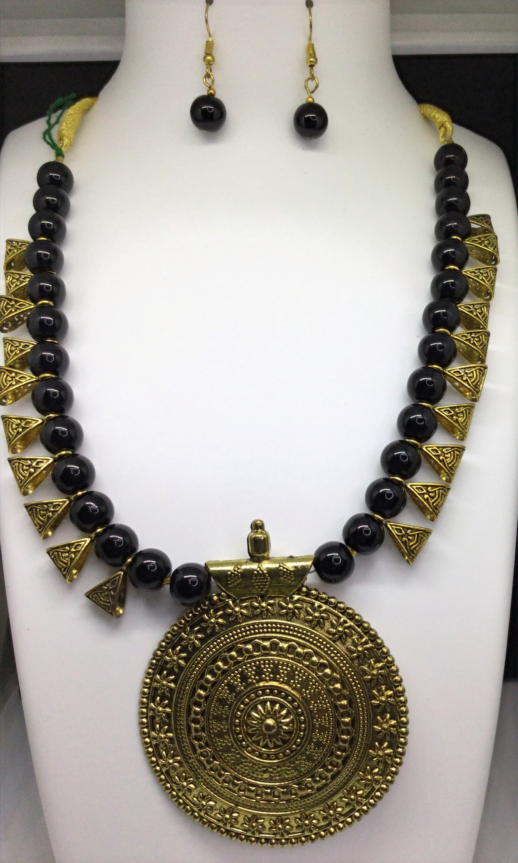Necklace and earring set — black and gold with a brass medallion