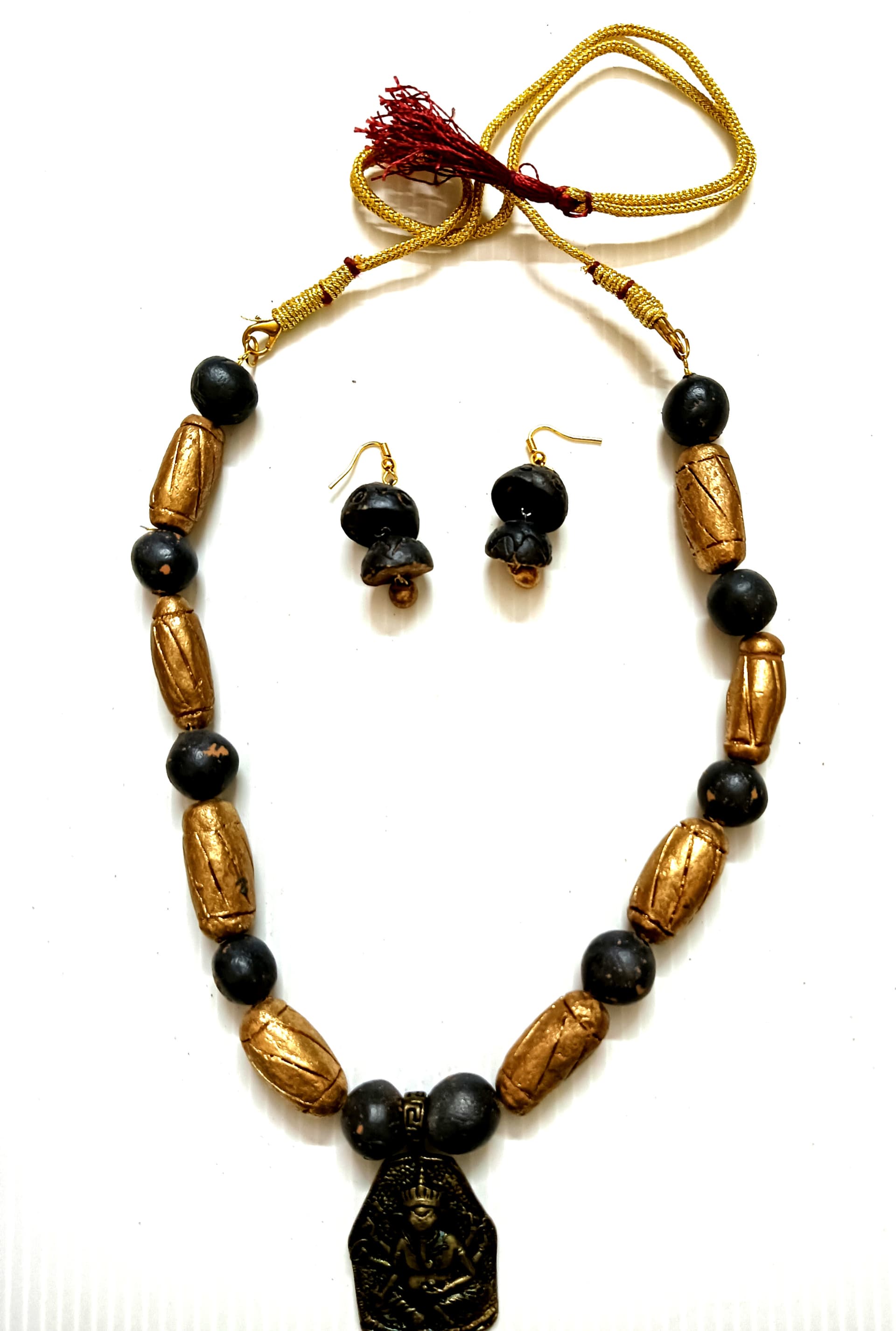 Necklace and earring set — brown and black with a brass pendant