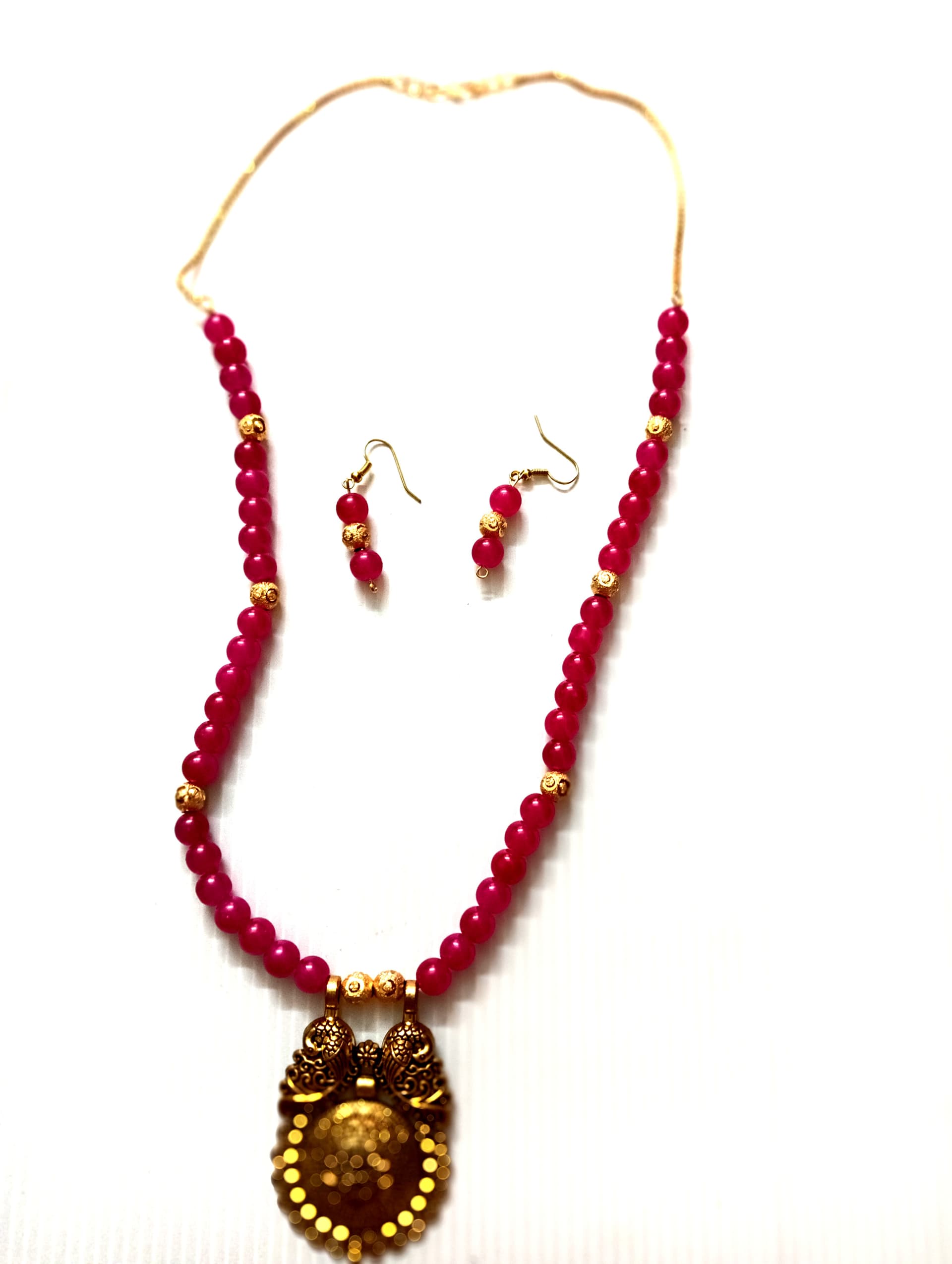 Necklace and earring set — red and wine with a brass oval pendant