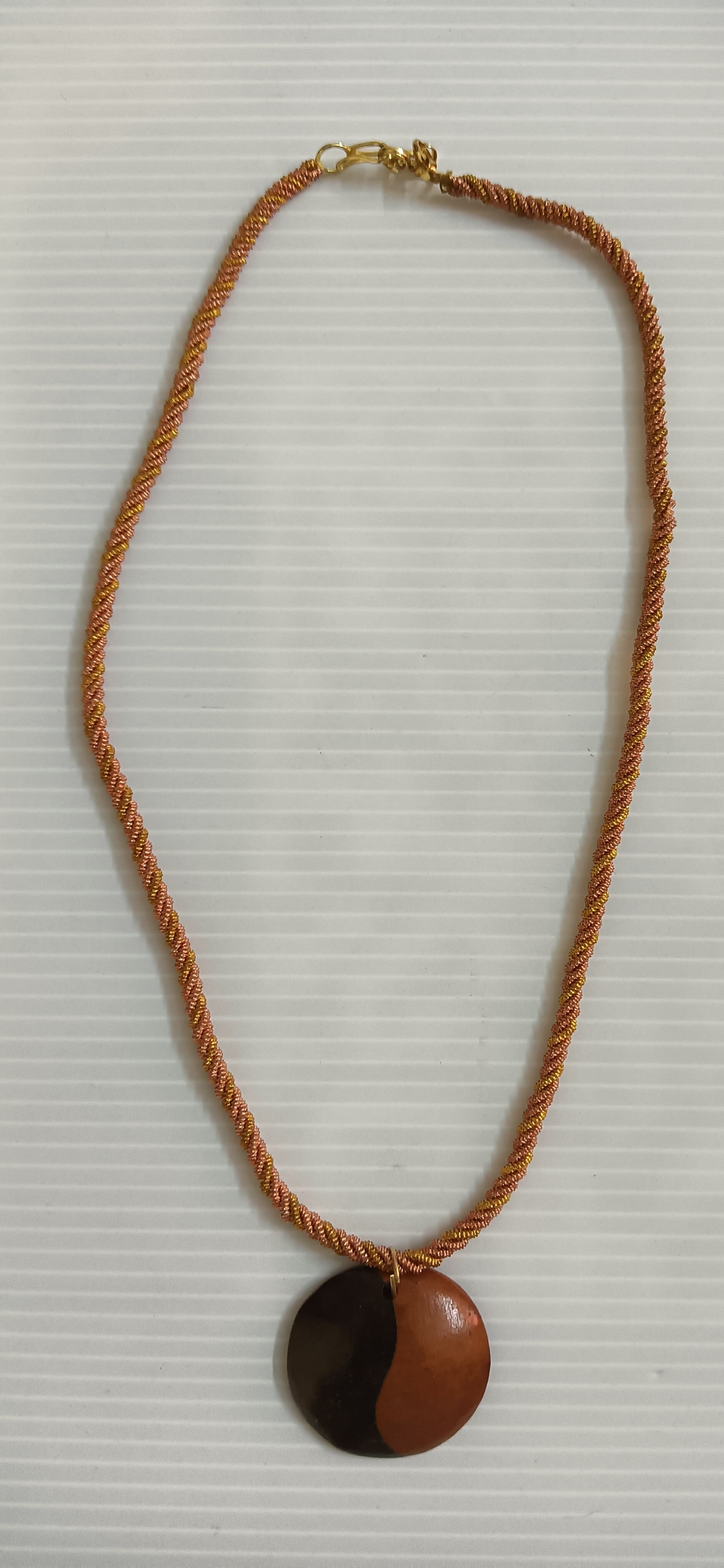 Handmade necklace — tan cord with a wooden disc pendant