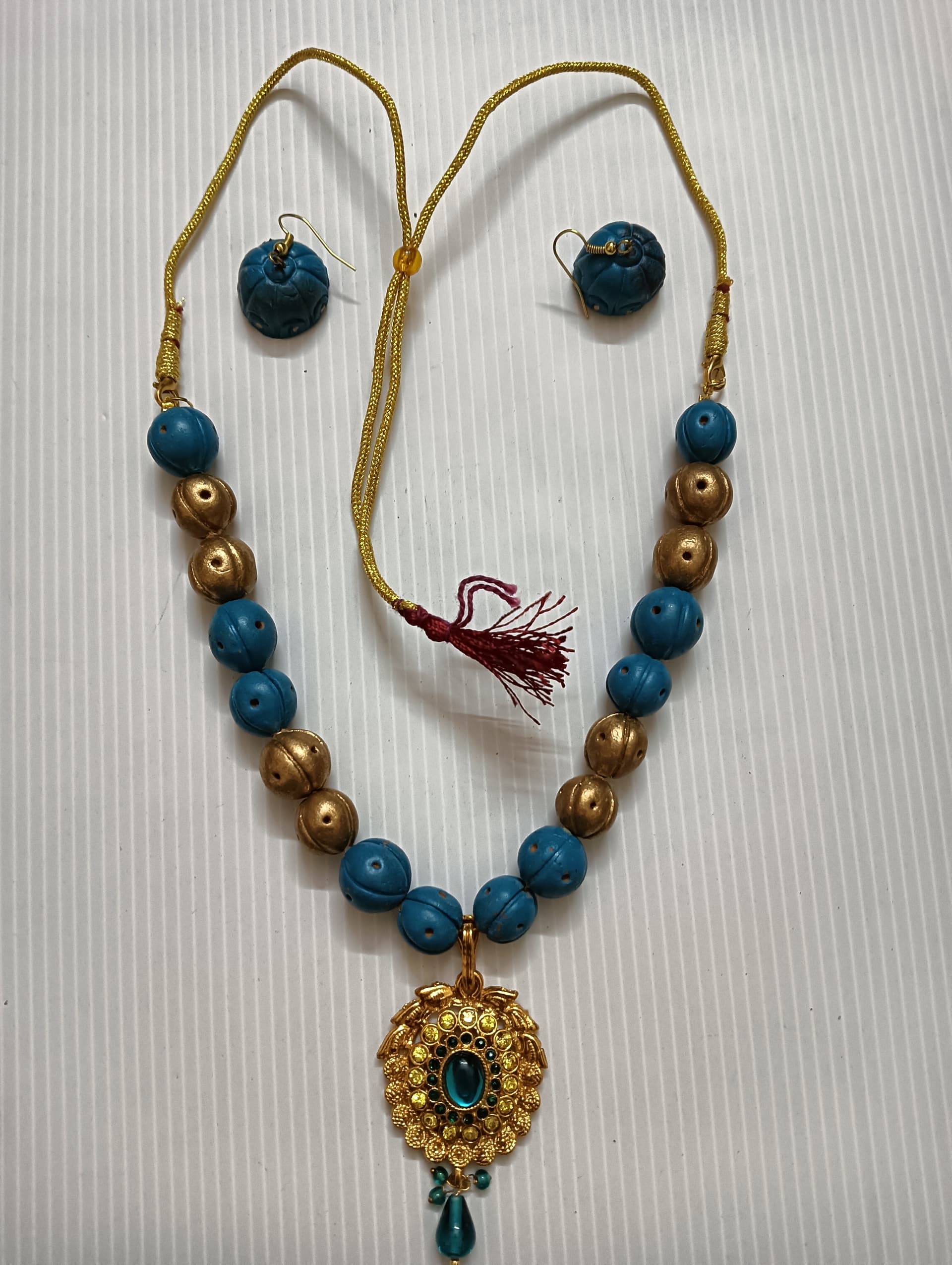Necklace and earring set — teal and gold with a blue medallion