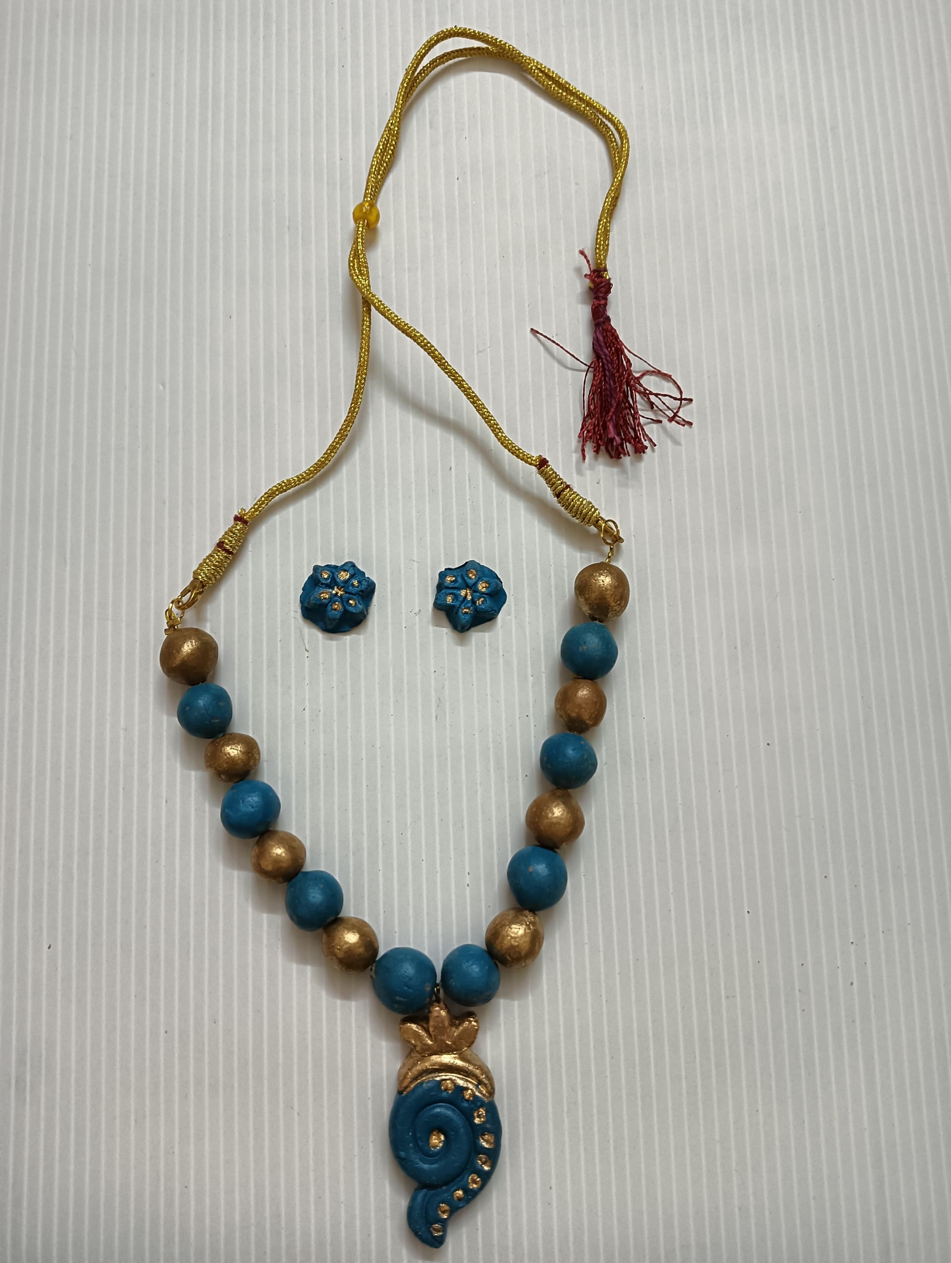 Necklace and earring set — teal and gold with a blue drop