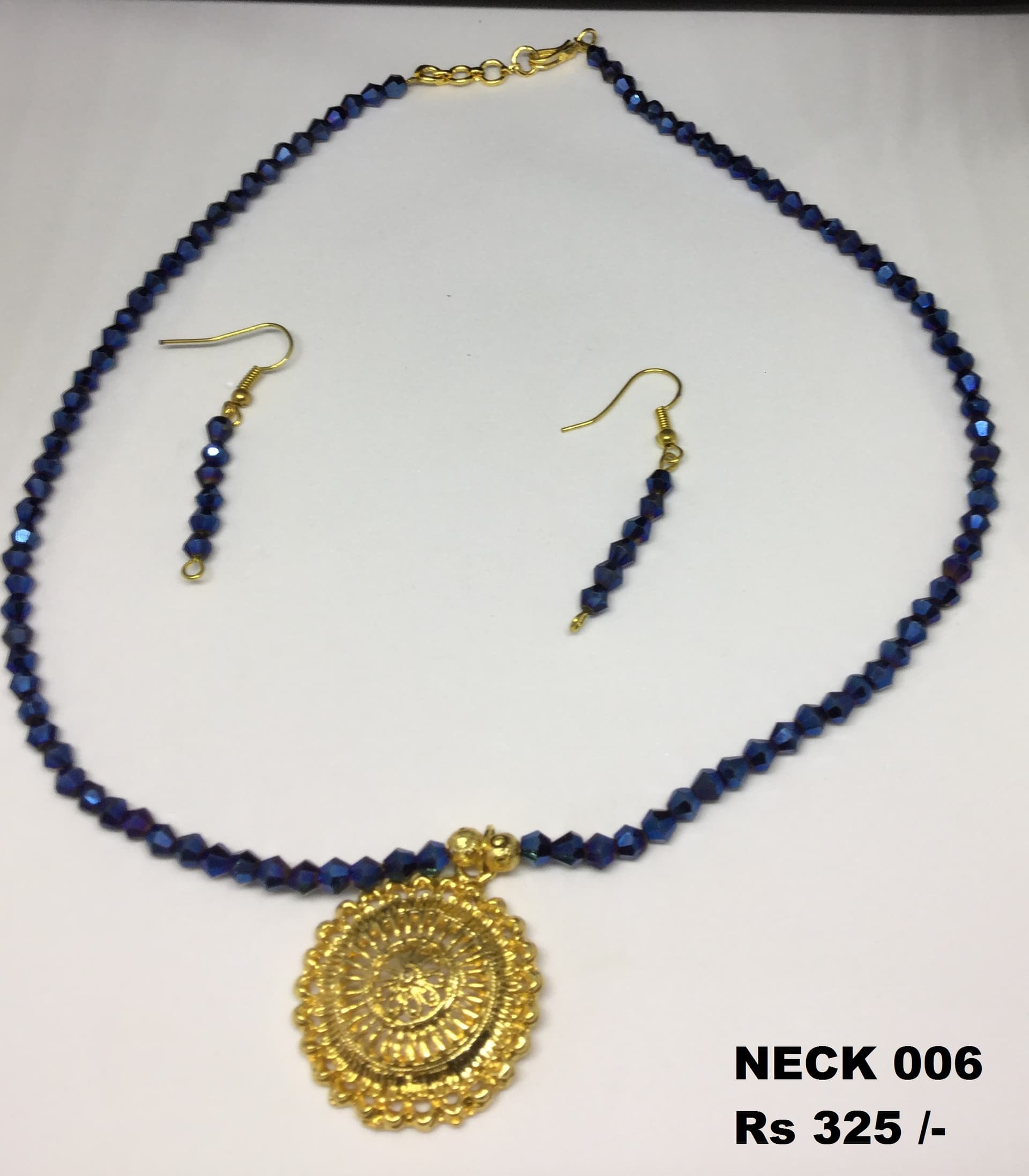 Necklace and earring set — navy blue with a gold medallion