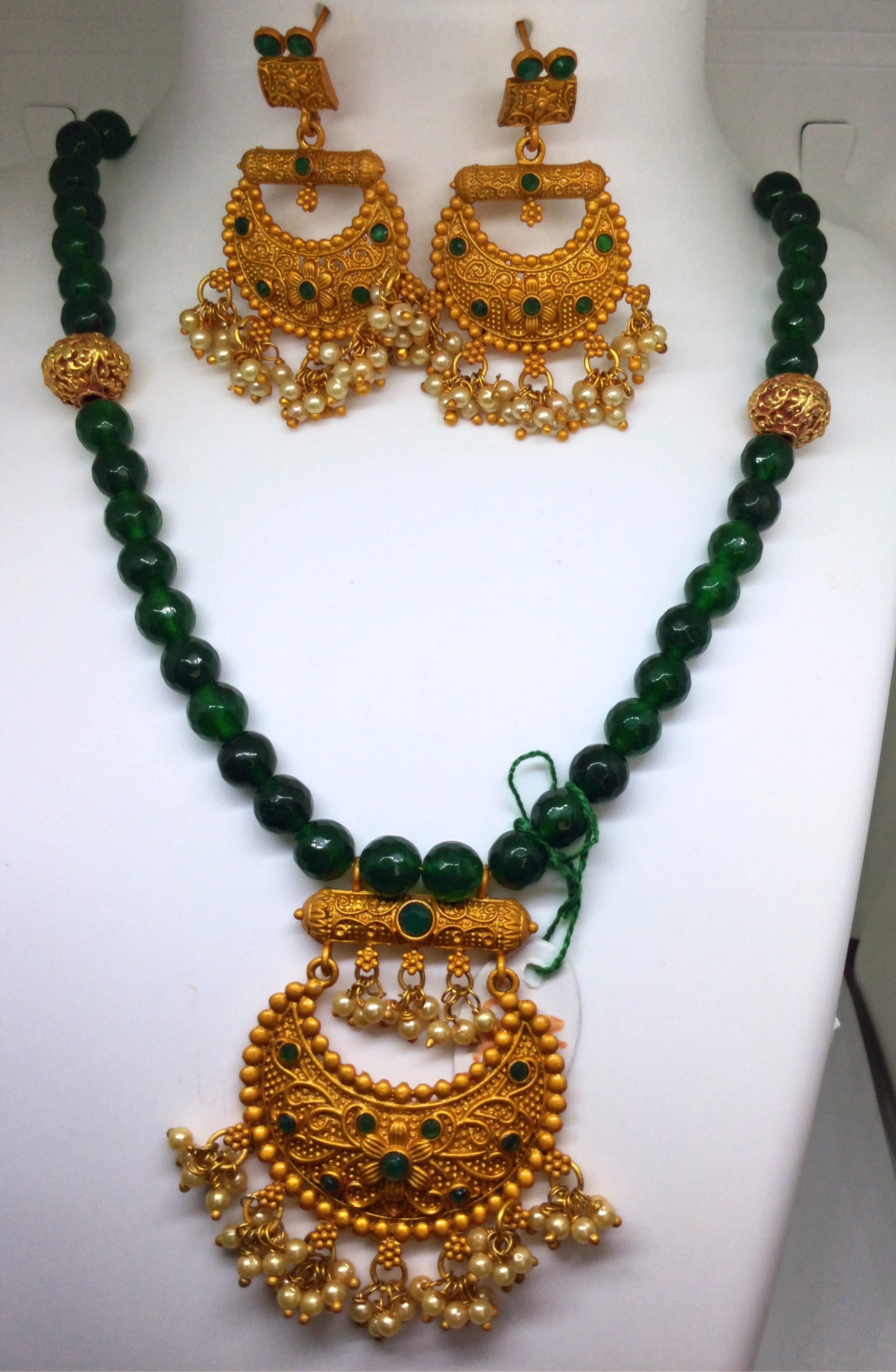 Necklace and jhumka earring set — emerald green with a gold pendant
