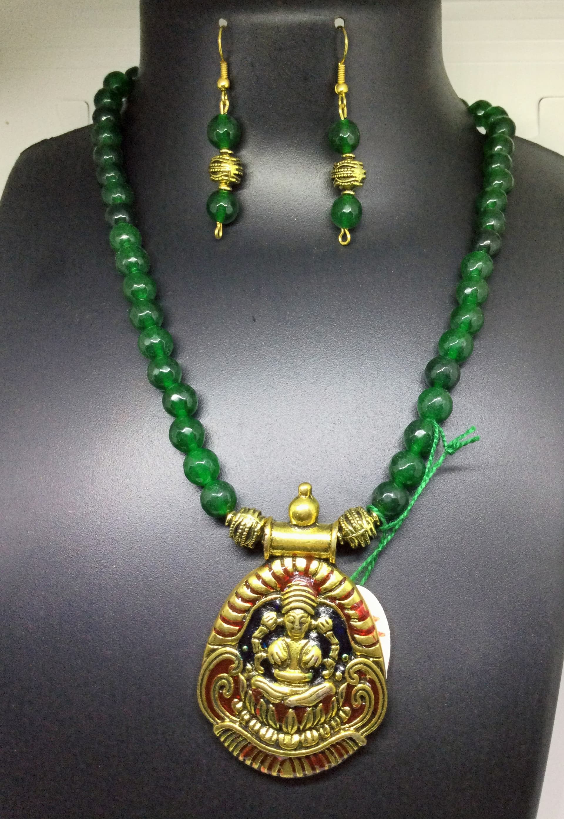 Necklace and earring set — emerald green with a gold temple pendant