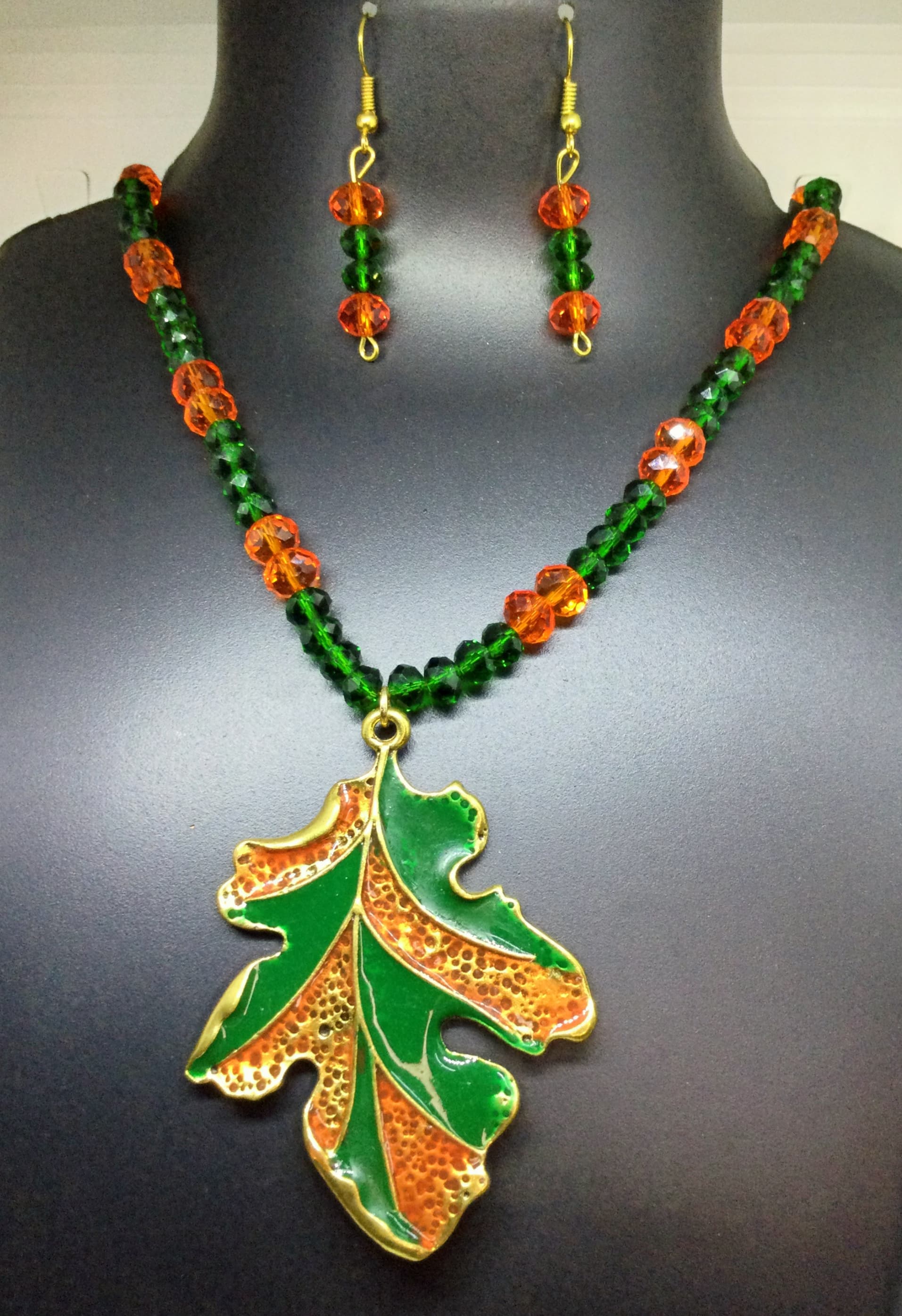 Necklace and earring set — green and orange with a painted leaf pendant