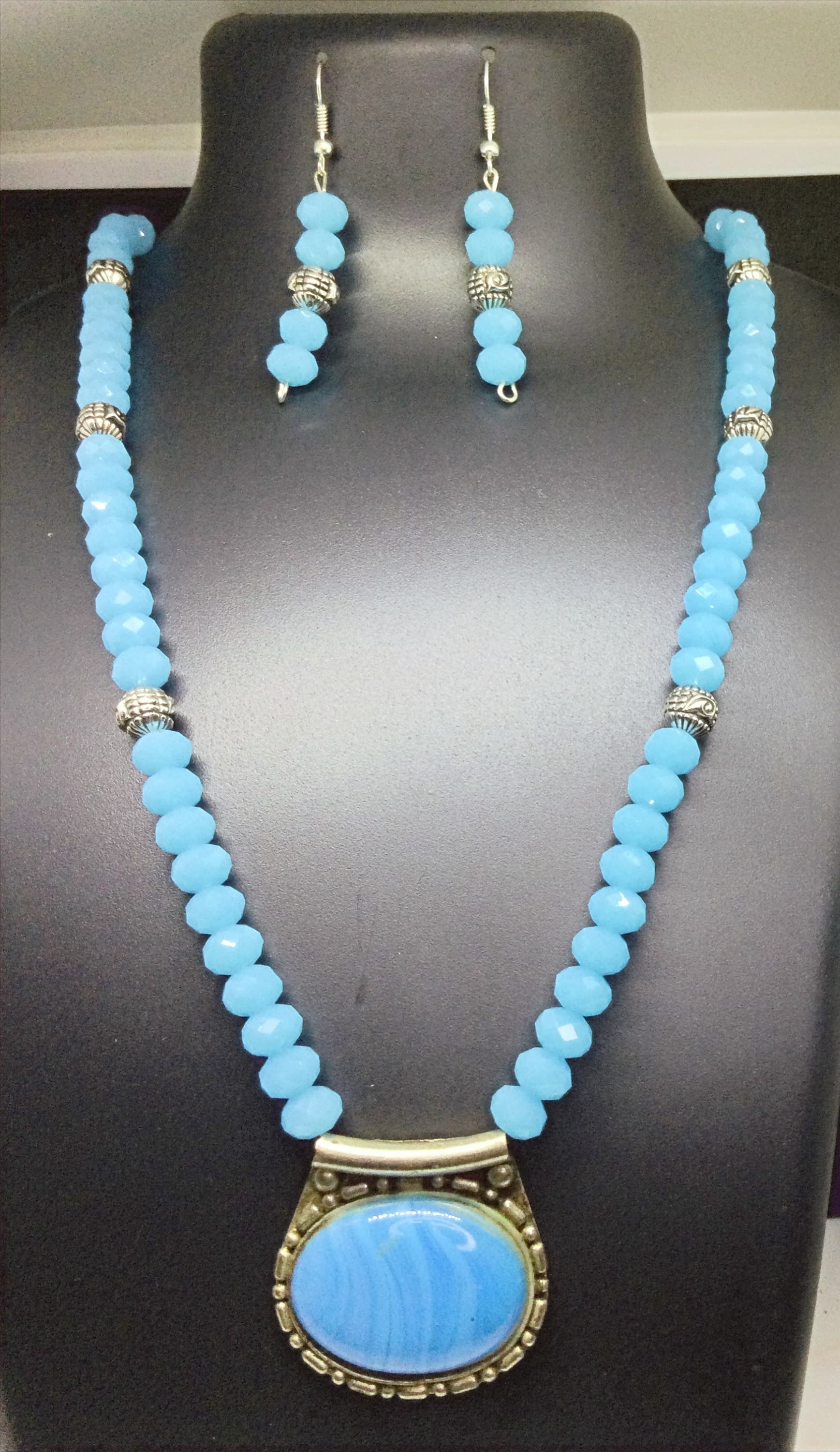 Necklace and earring set — pale blue with a blue stone pendant