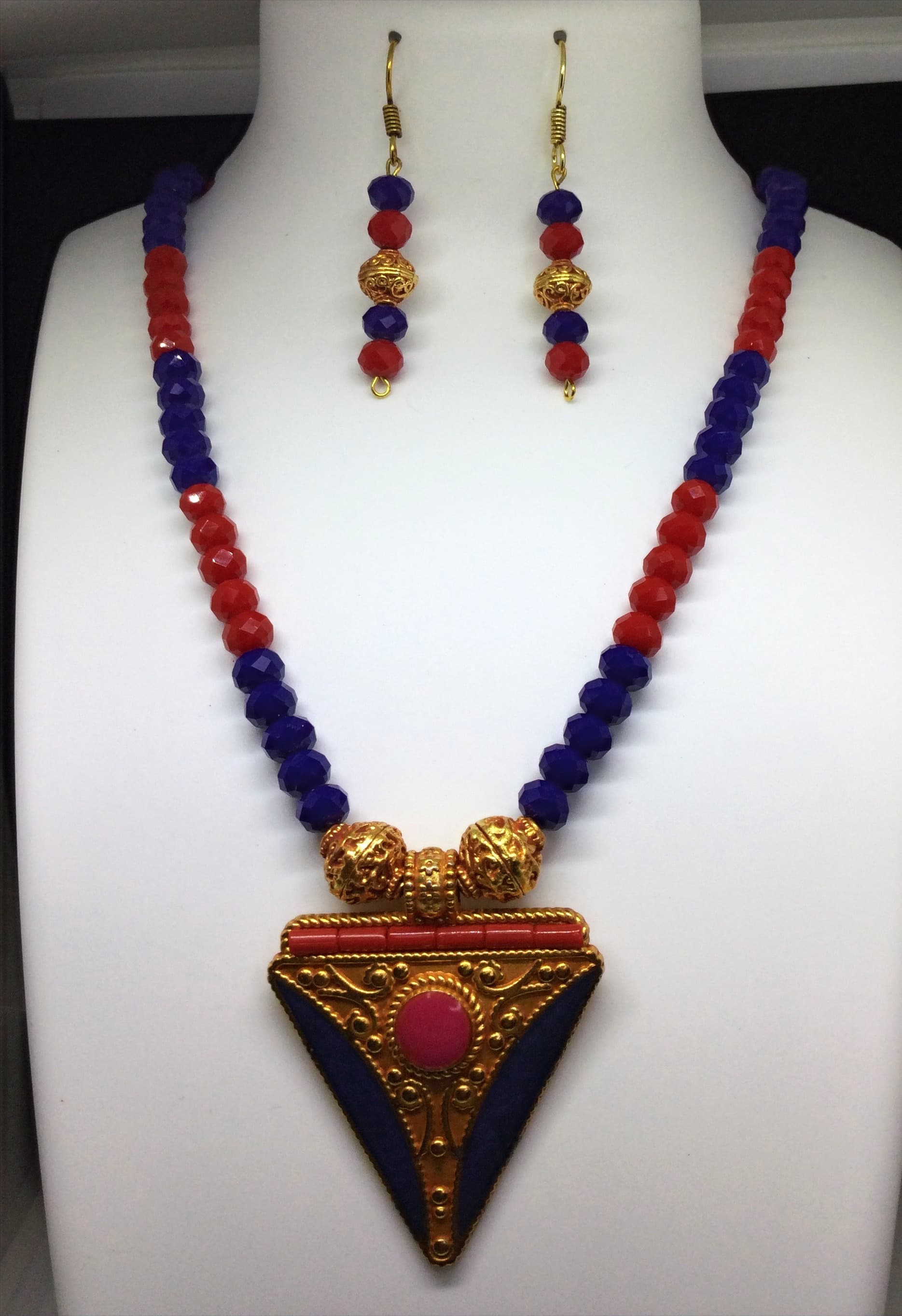 Necklace and earring set — blue and red with a gold and coral pendant