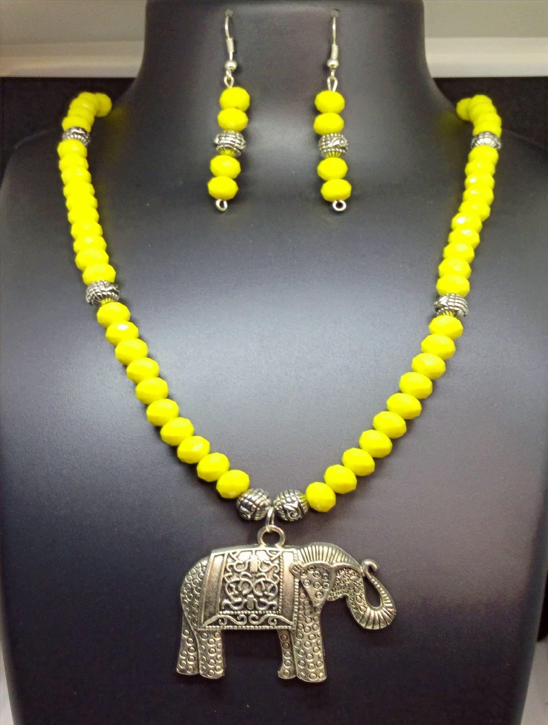 Necklace and earring set — yellow with a silver elephant pendant