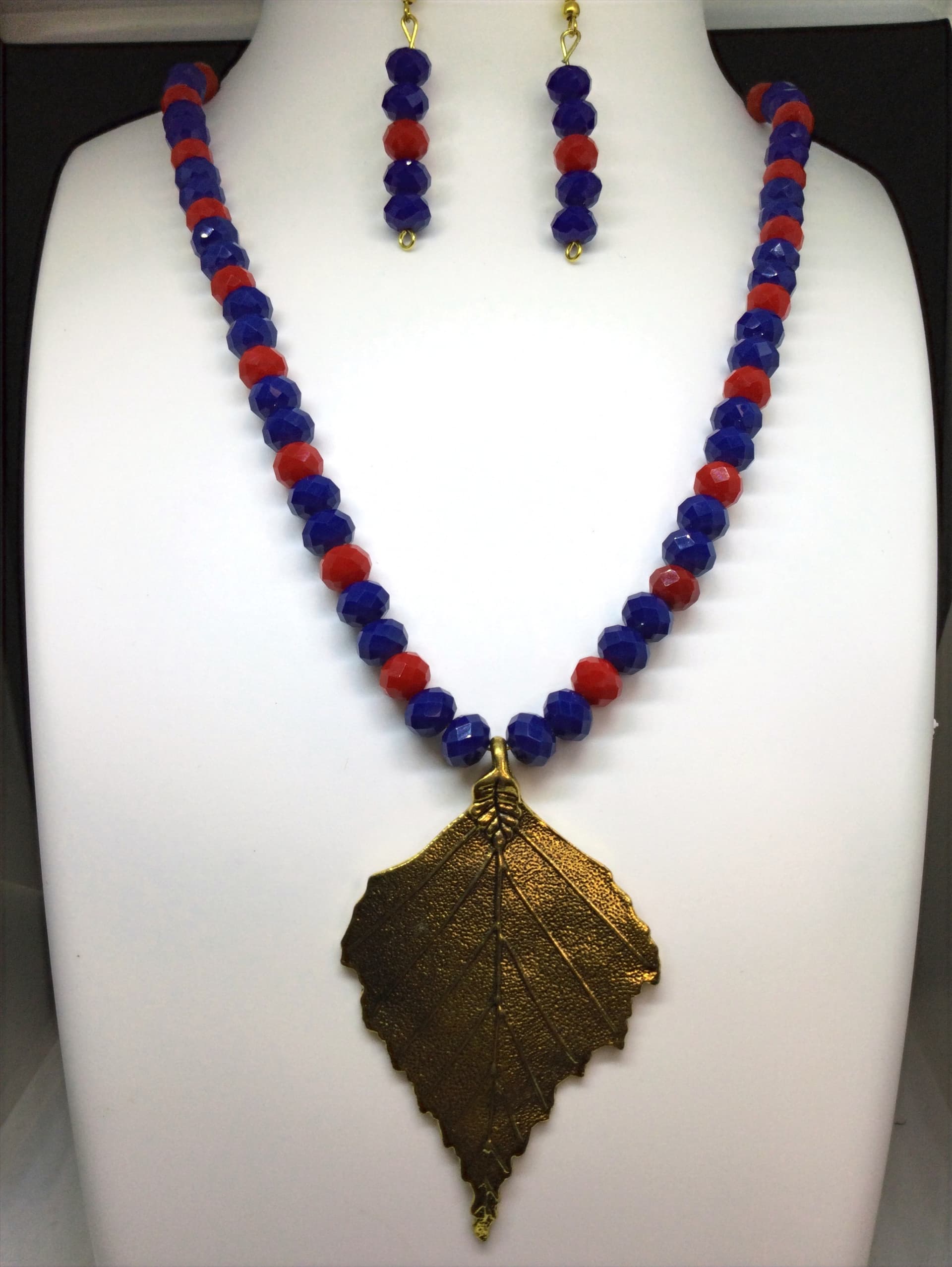 Necklace and earring set — blue and red with a brass leaf pendant