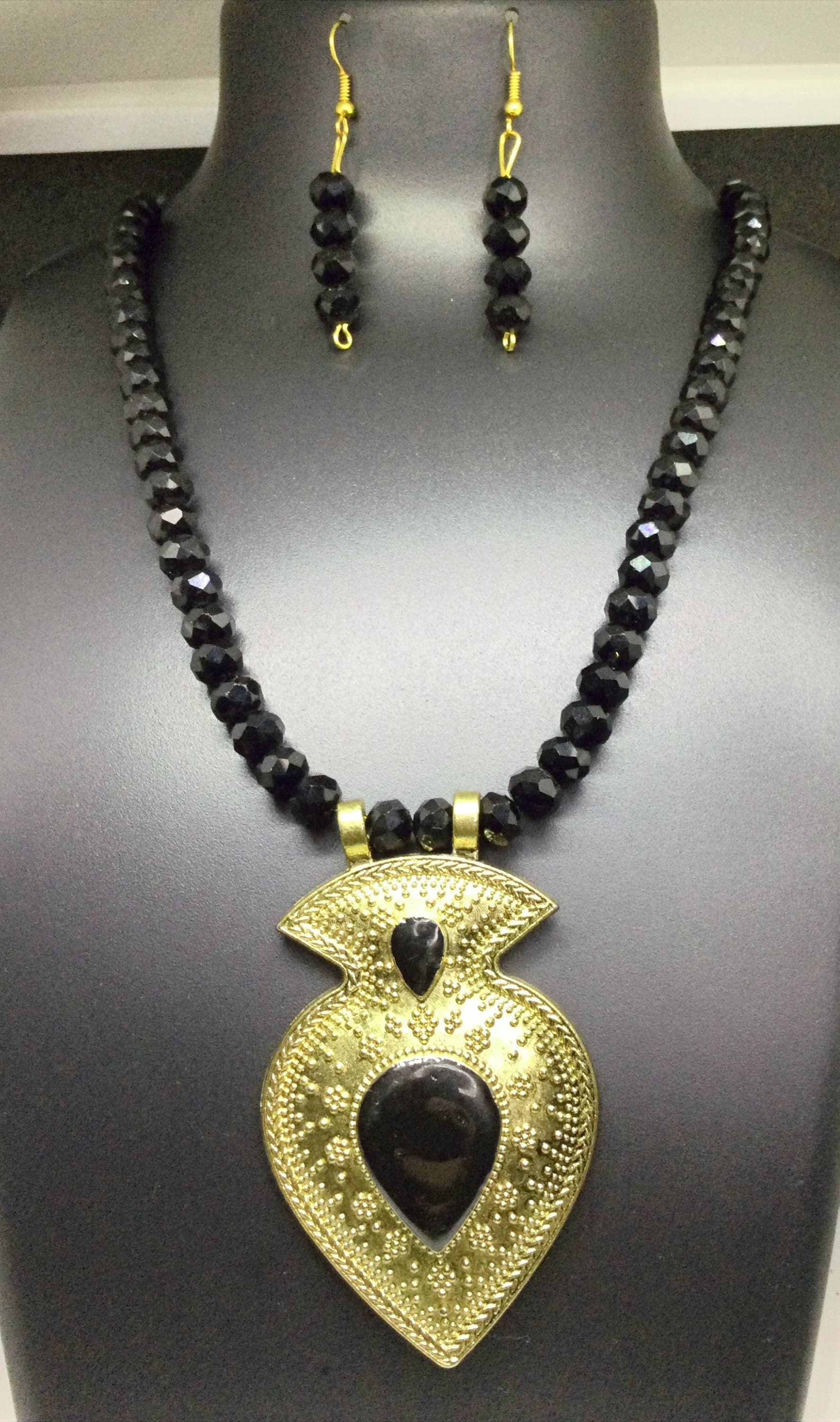 Necklace and earring set — black with a brass paisley pendant