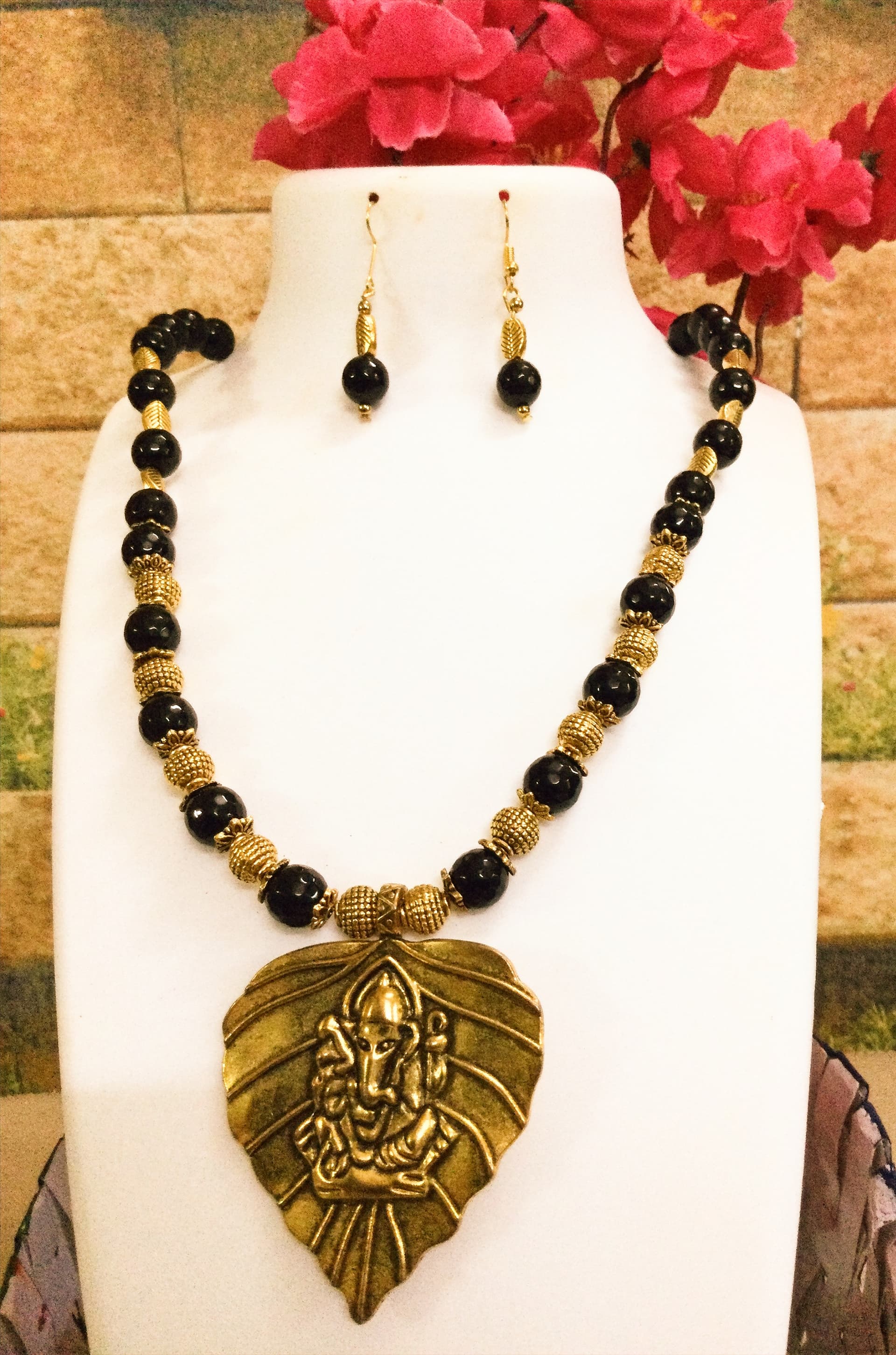 Necklace and earring set — black and gold with a brass leaf pendant