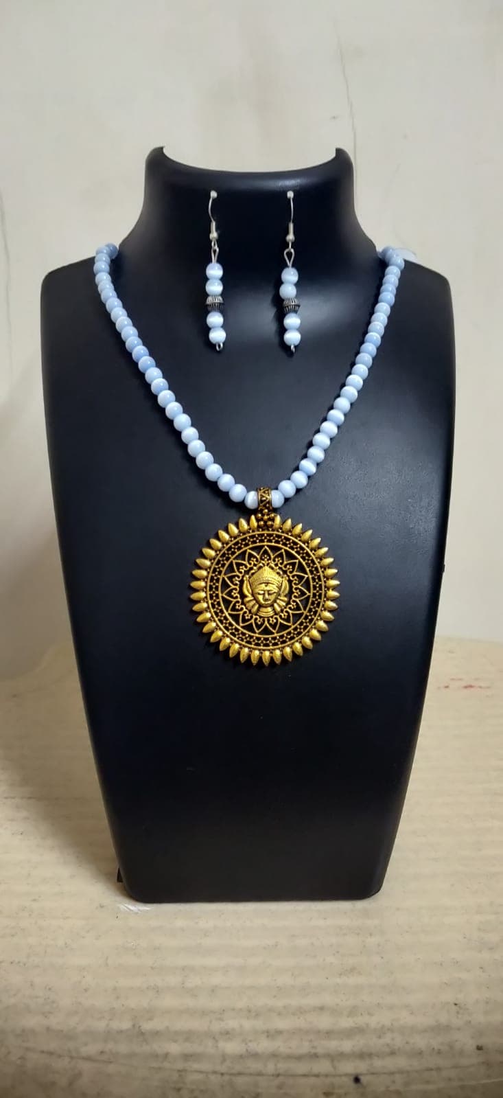 Necklace and earring set — white with a brass medallion