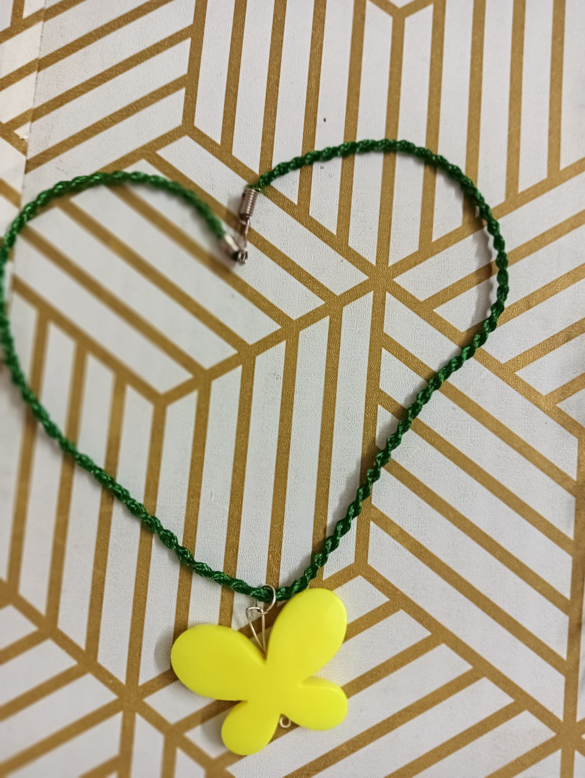 Handmade necklace — dark green thread with a yellow flower