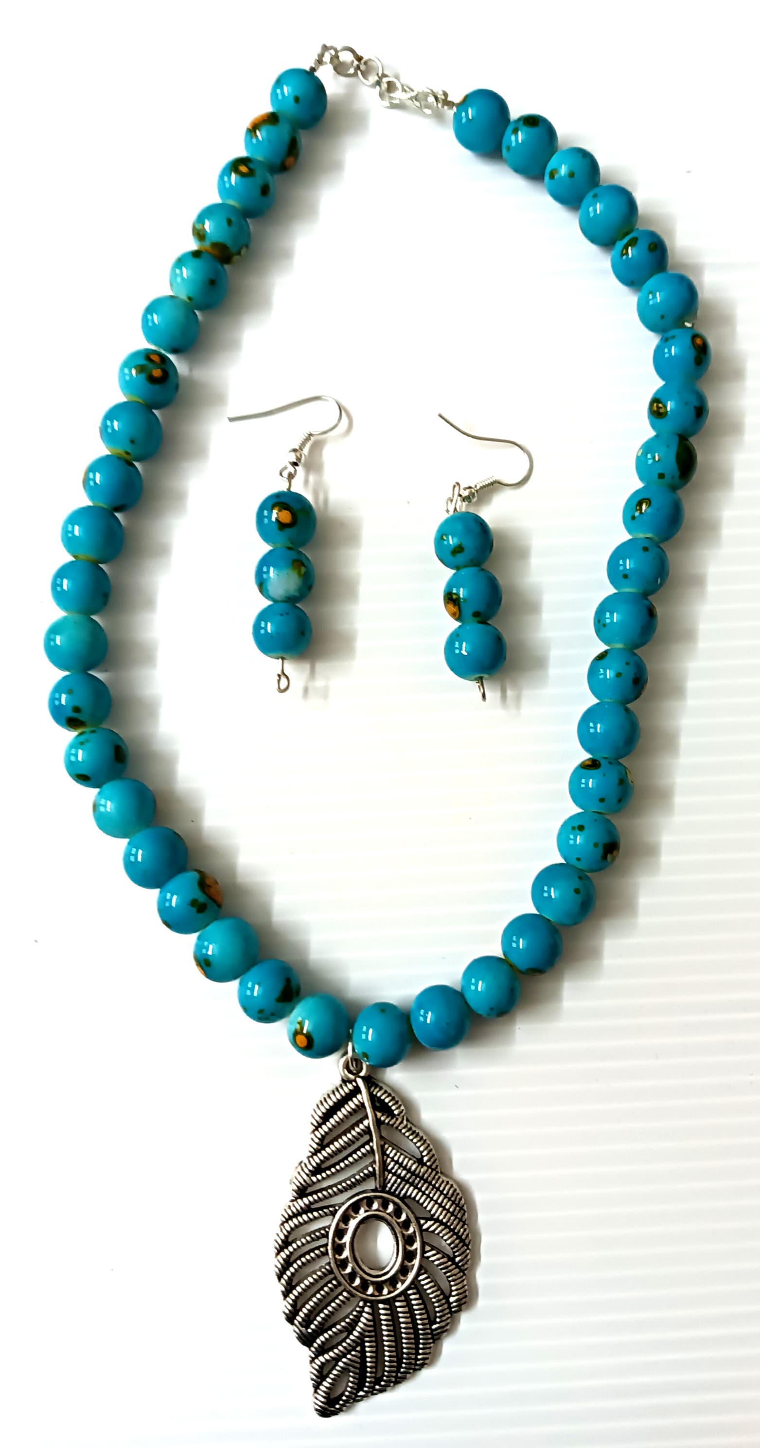 Necklace and earring set — teal with a silver feather pendant