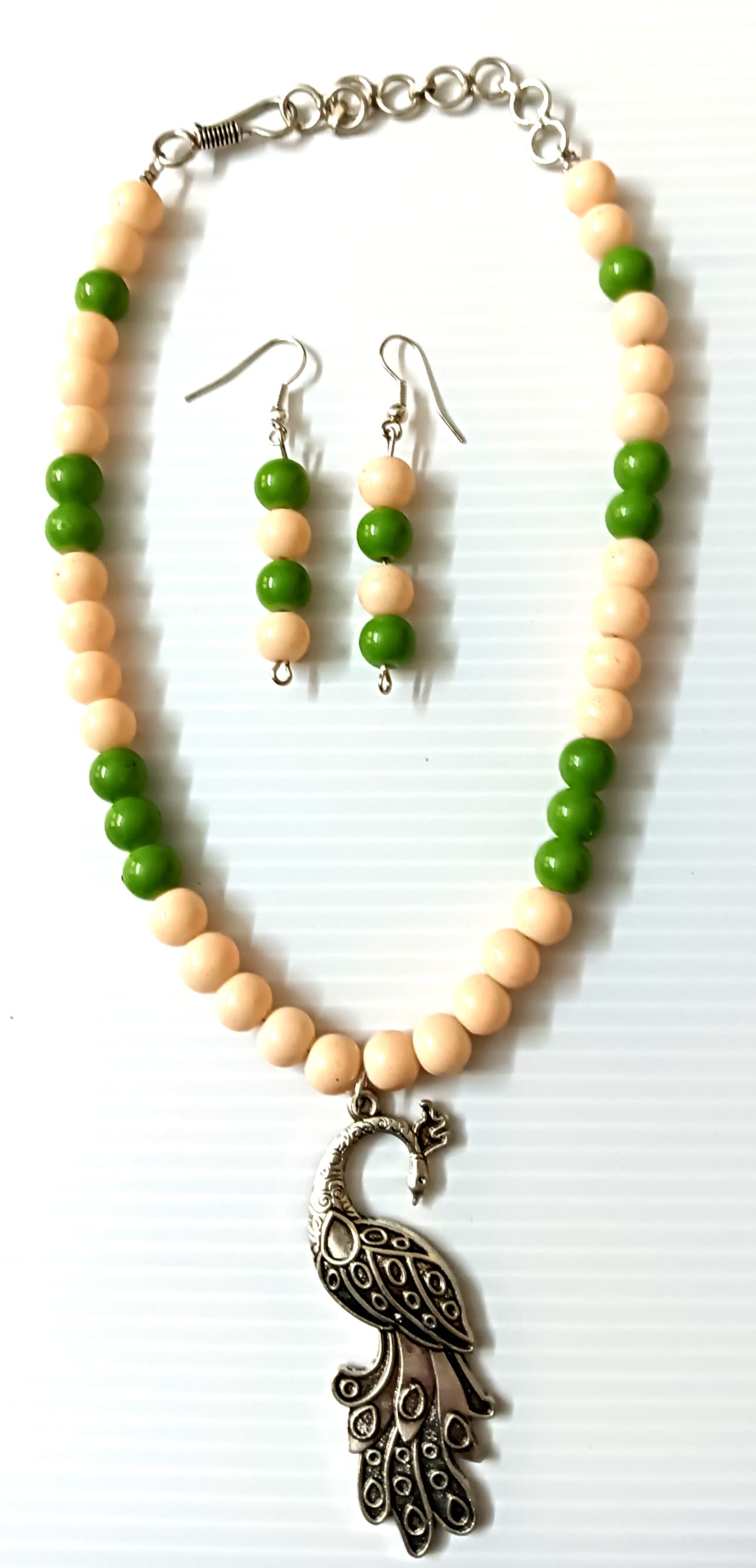 Peacock necklace and earring set — green and cream with a brass peacock pendant