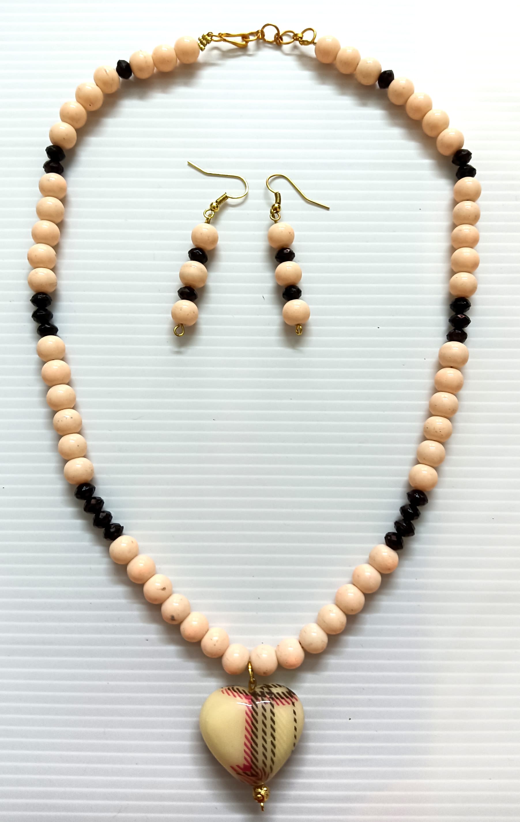 Necklace and earring set — cream and black with a brass drop