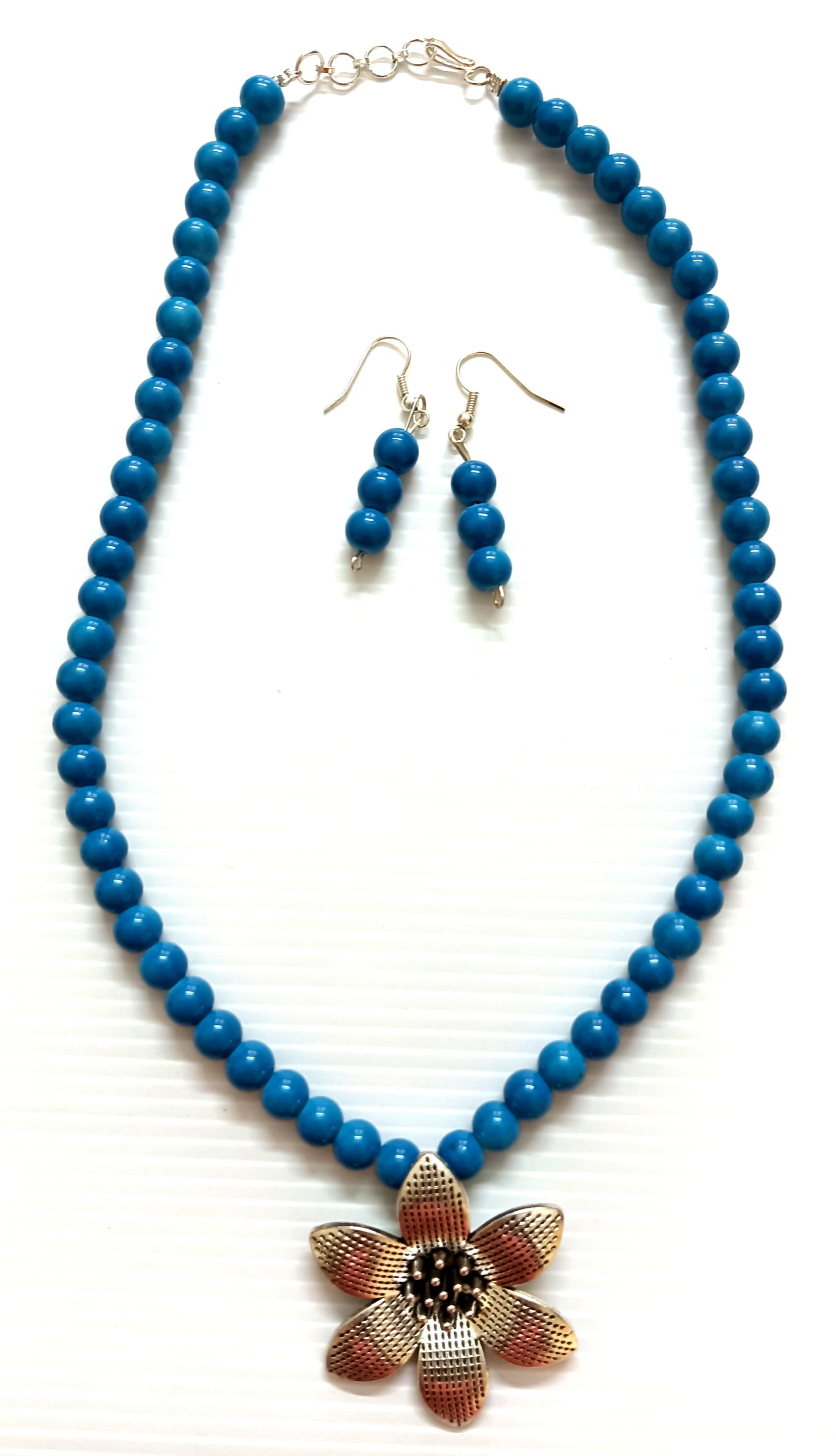 Necklace and earring set — teal with a brass flower pendant