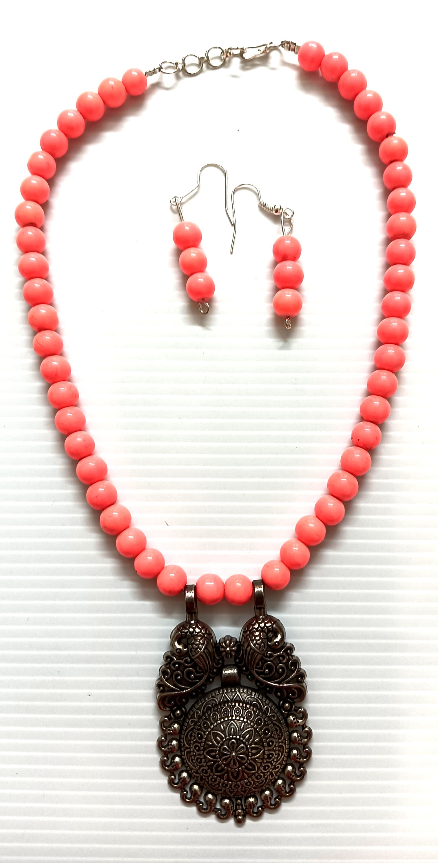 Necklace and earring set — coral with a brass medallion