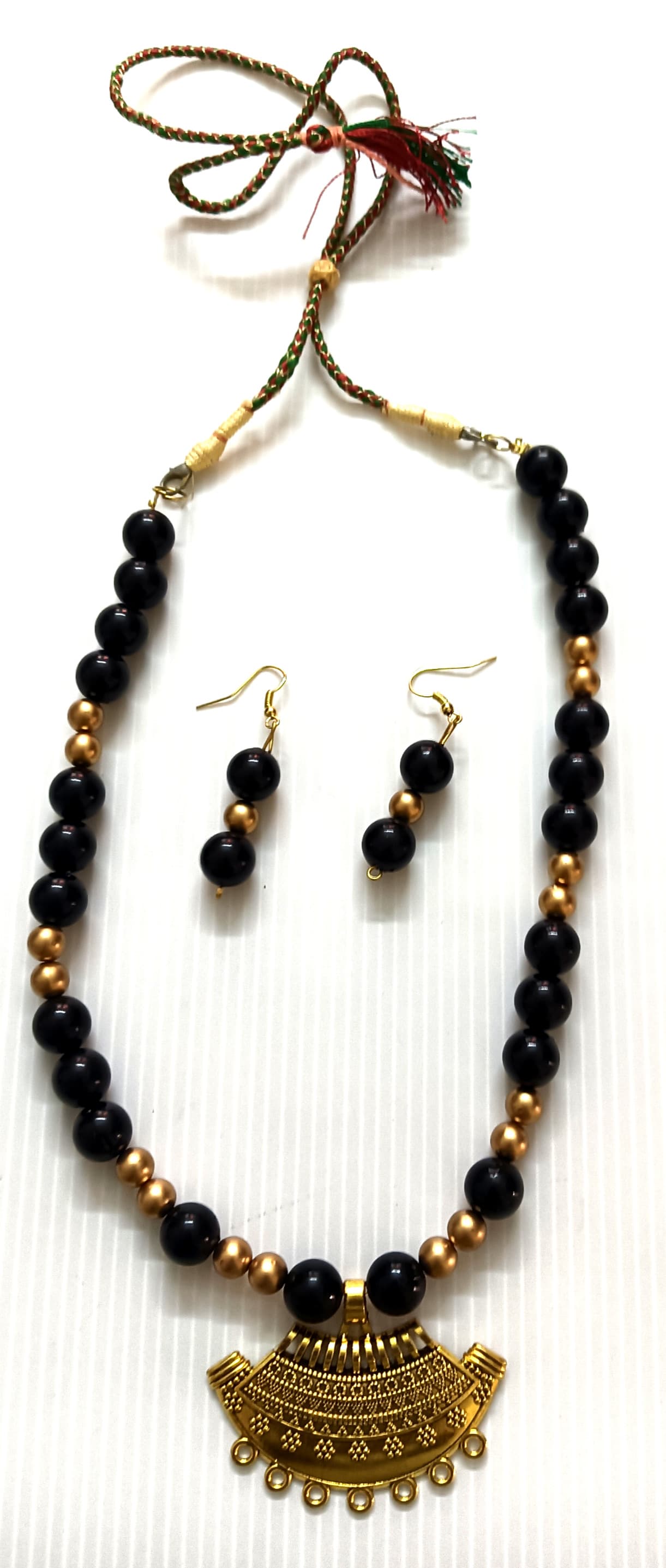 Necklace and earring set — navy and gold with a brass fan pendant