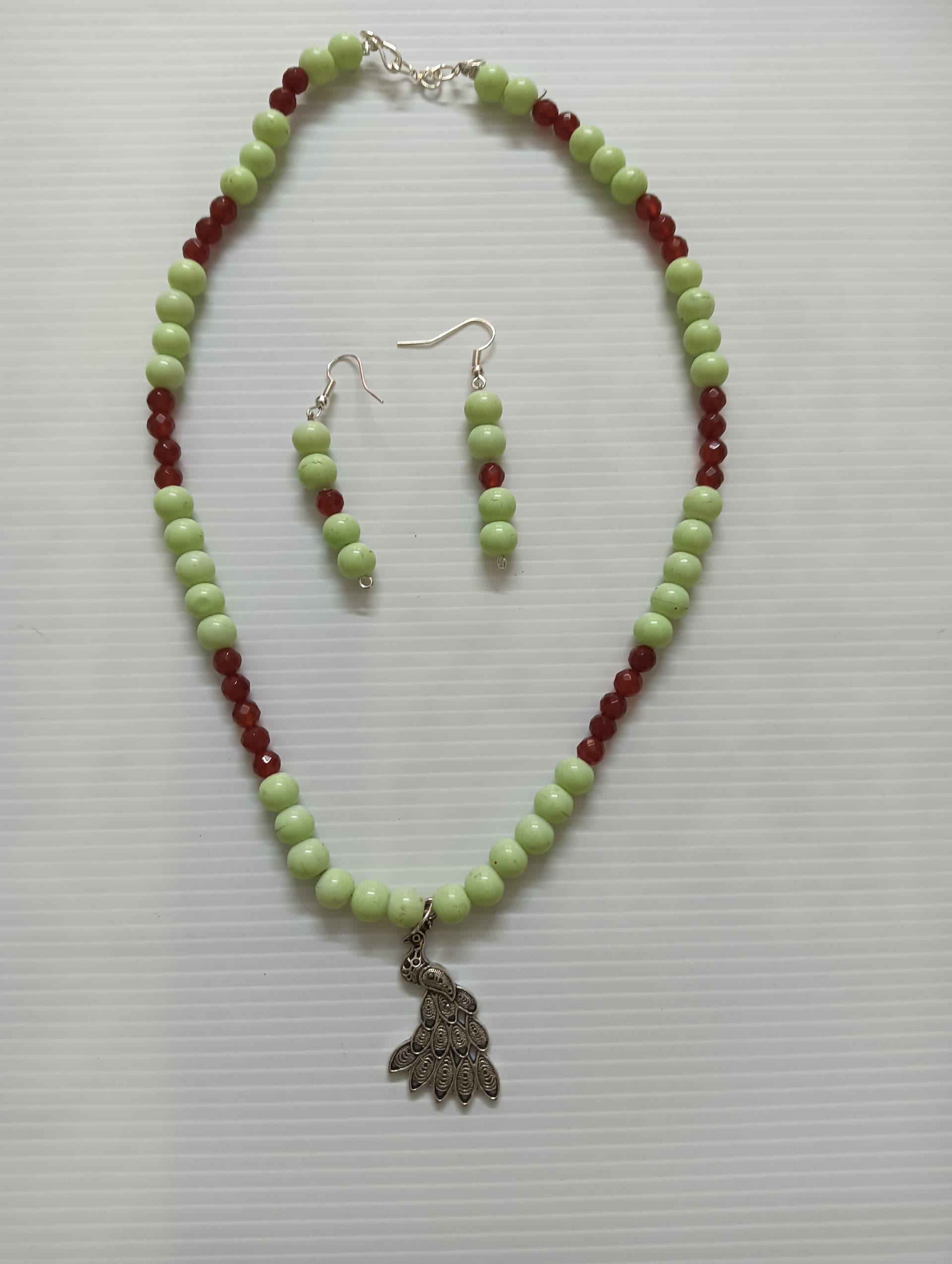 Necklace and earring set — pale green with a brass pendant