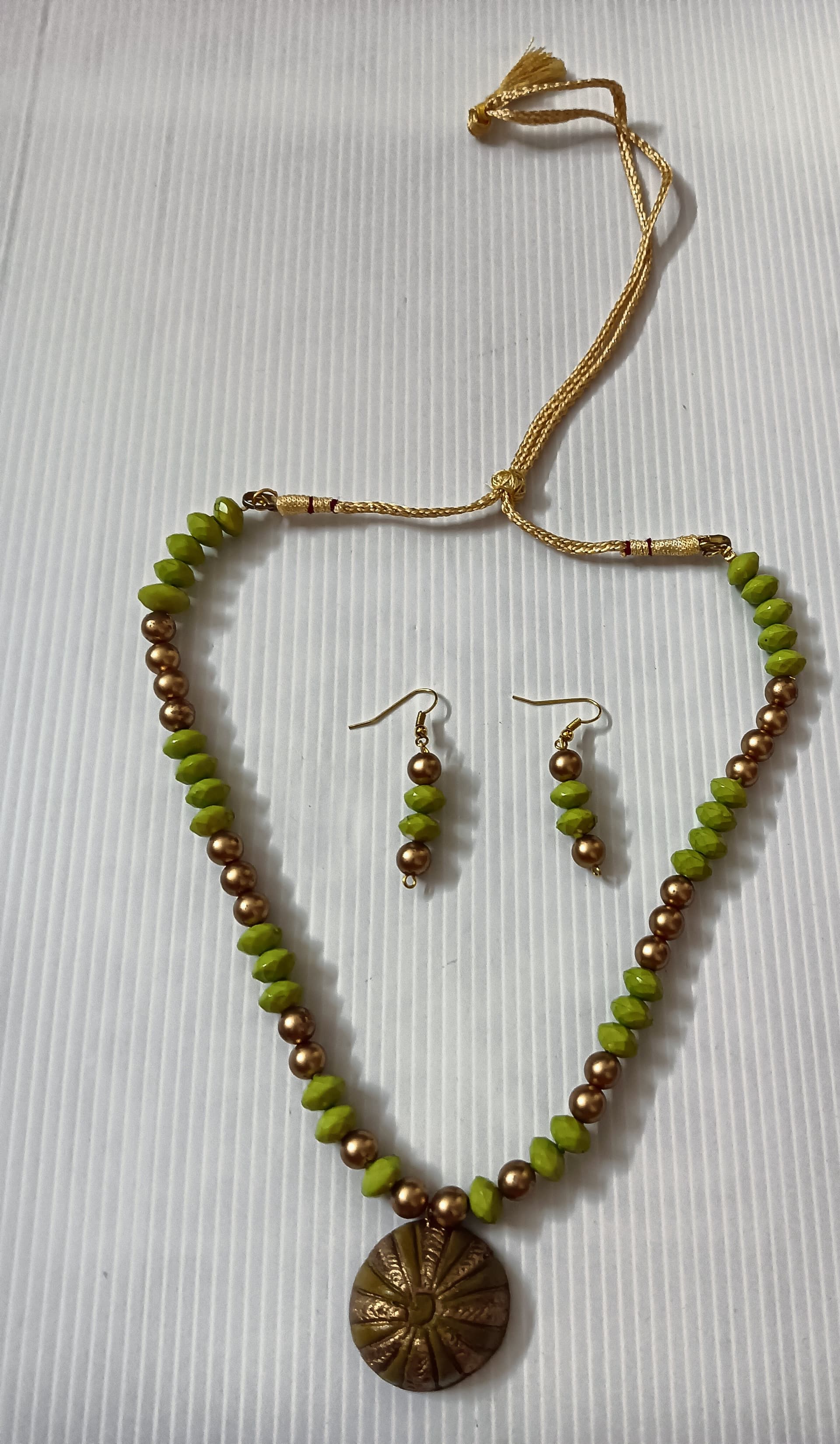 Necklace and earring set — olive green with a brass medallion