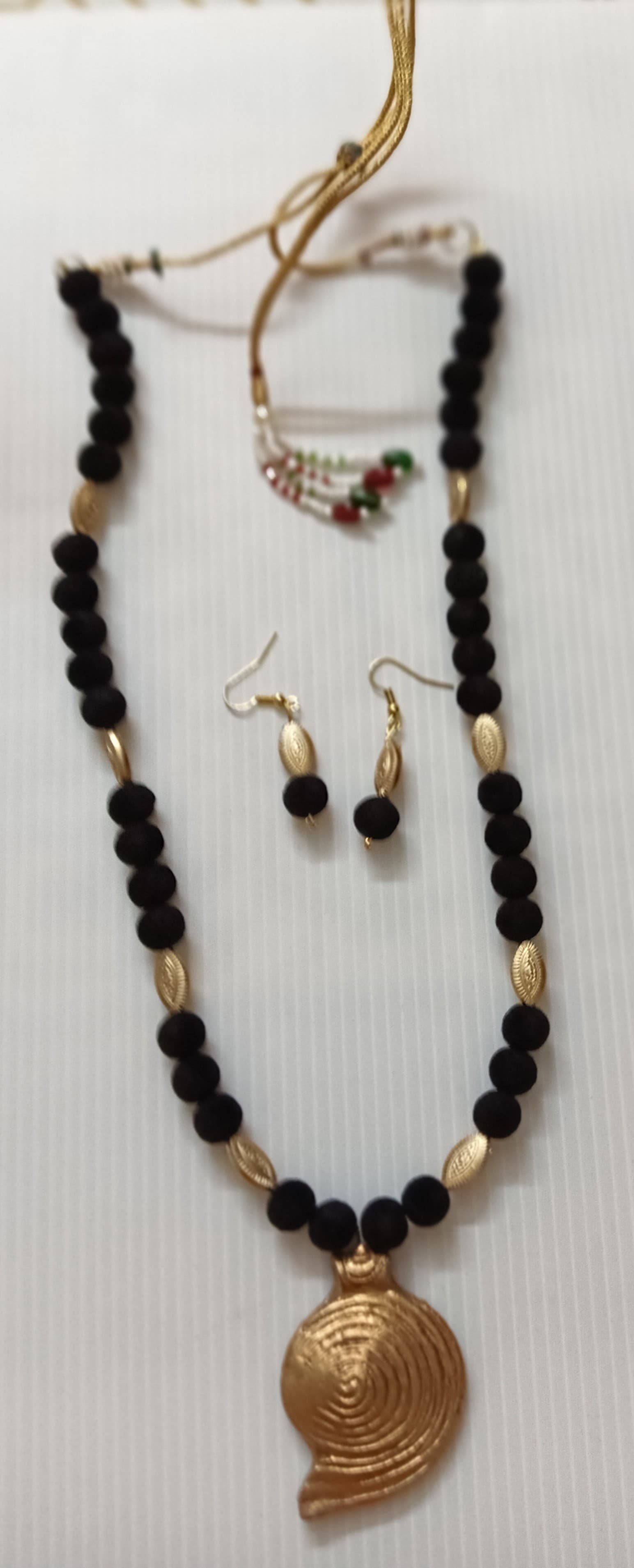 Necklace and earring set — black and gold with a brass pendant