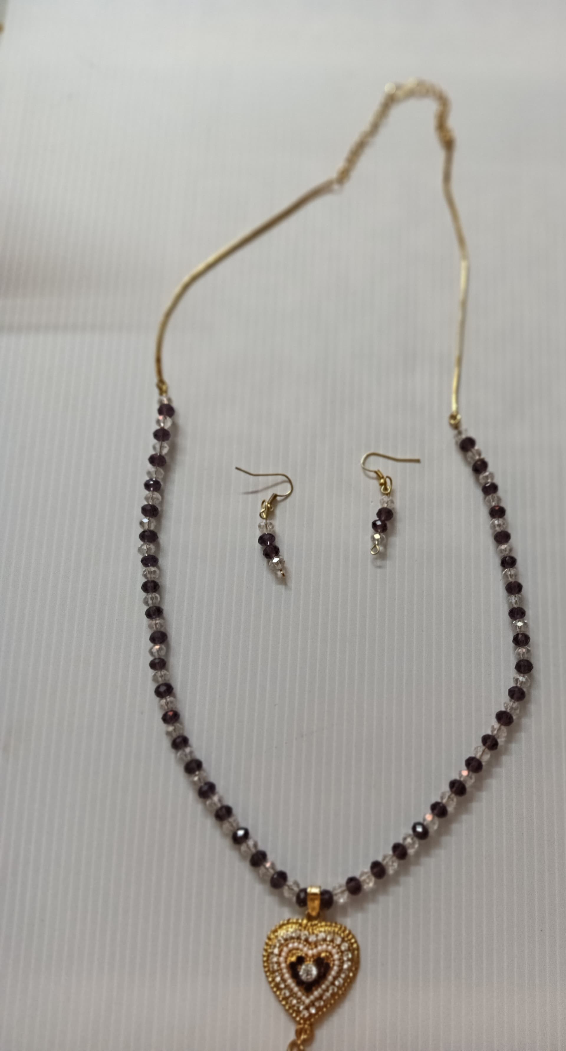 Necklace and earring set — violet and gold with a brass heart