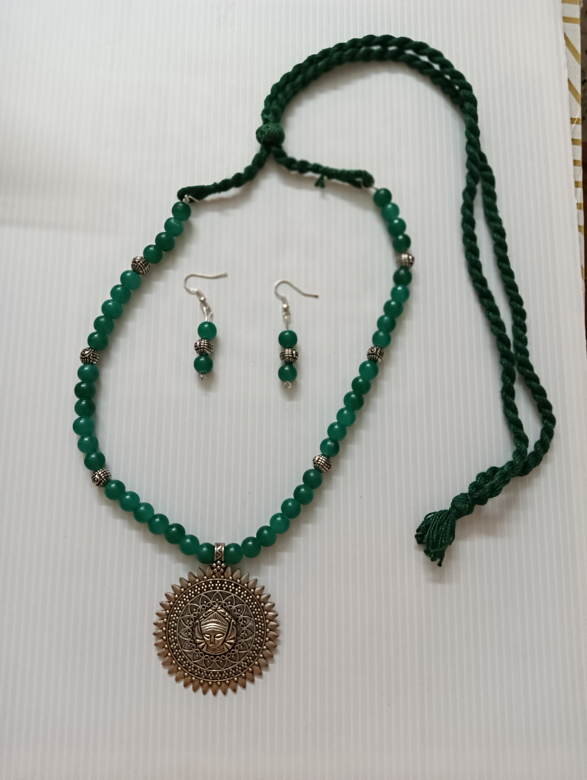 Necklace and earring set — green with a brass sun medallion