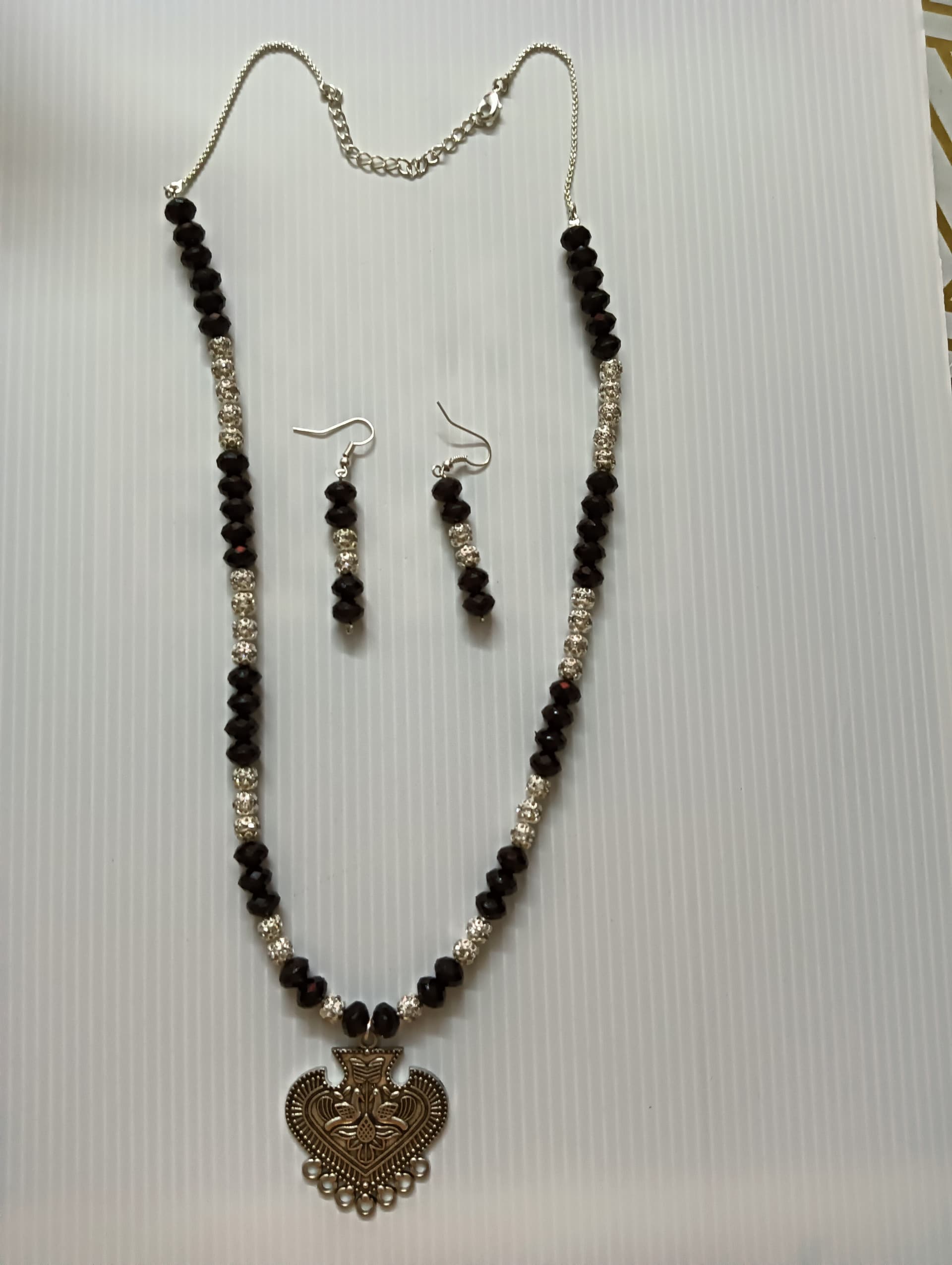 Necklace and earring set — black and cream with a brass heart