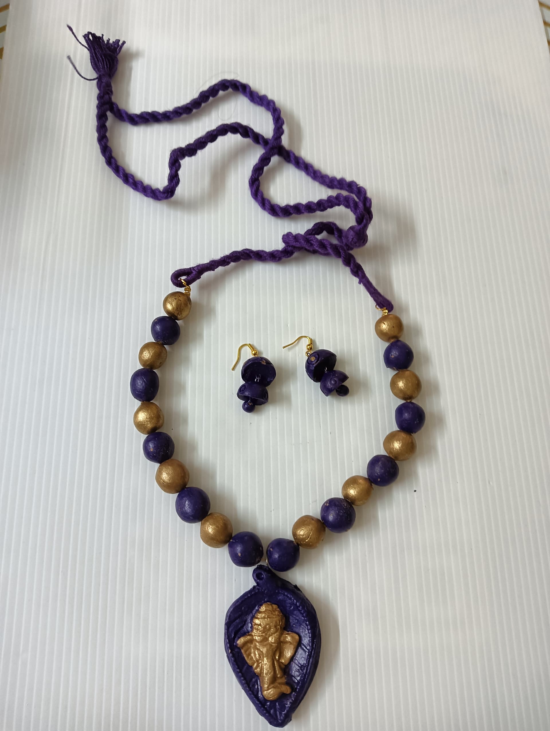 Necklace and earring set — violet thread with a blue enamel paisley