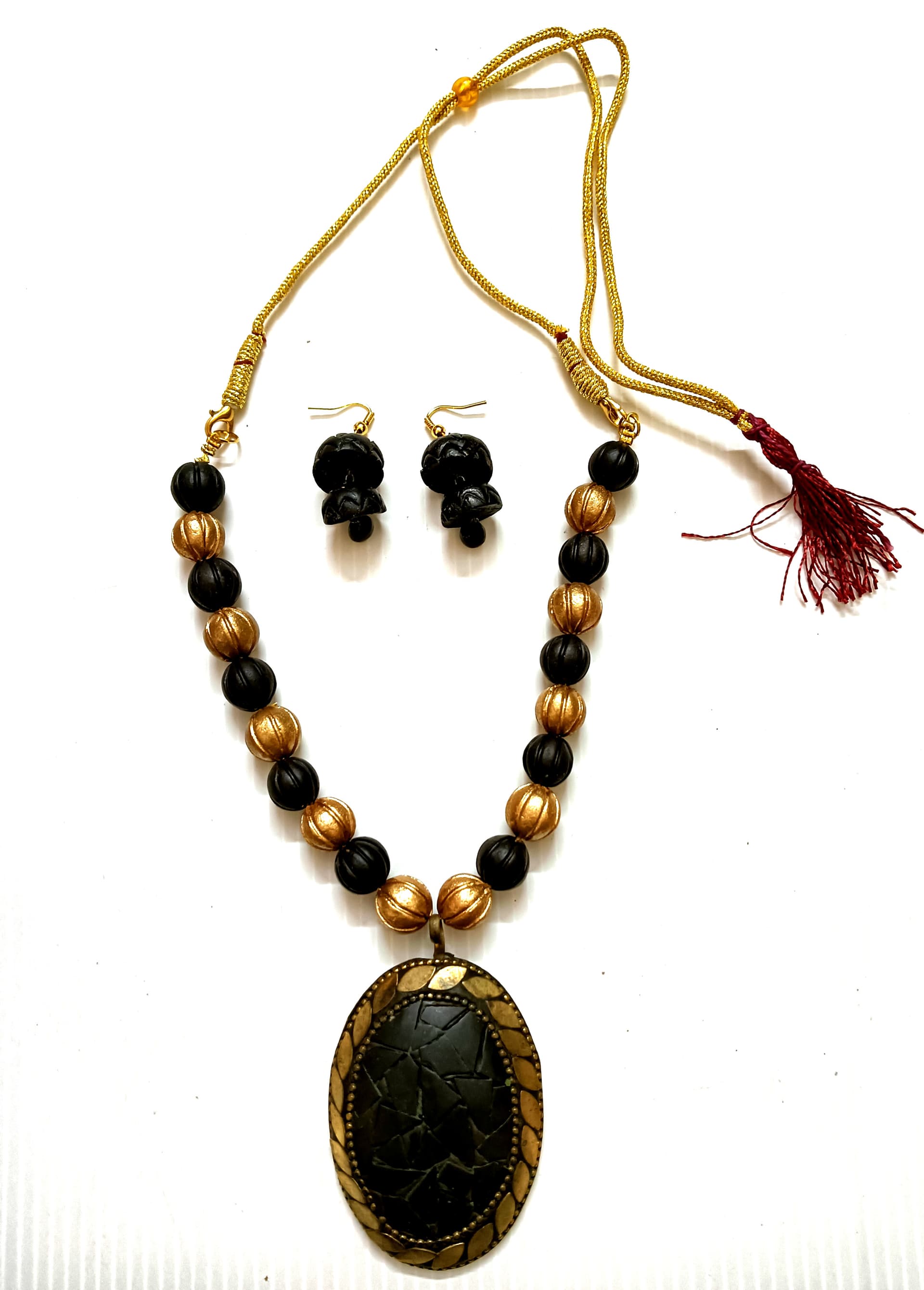 Necklace and earring set — black and gold with a dark oval pendant