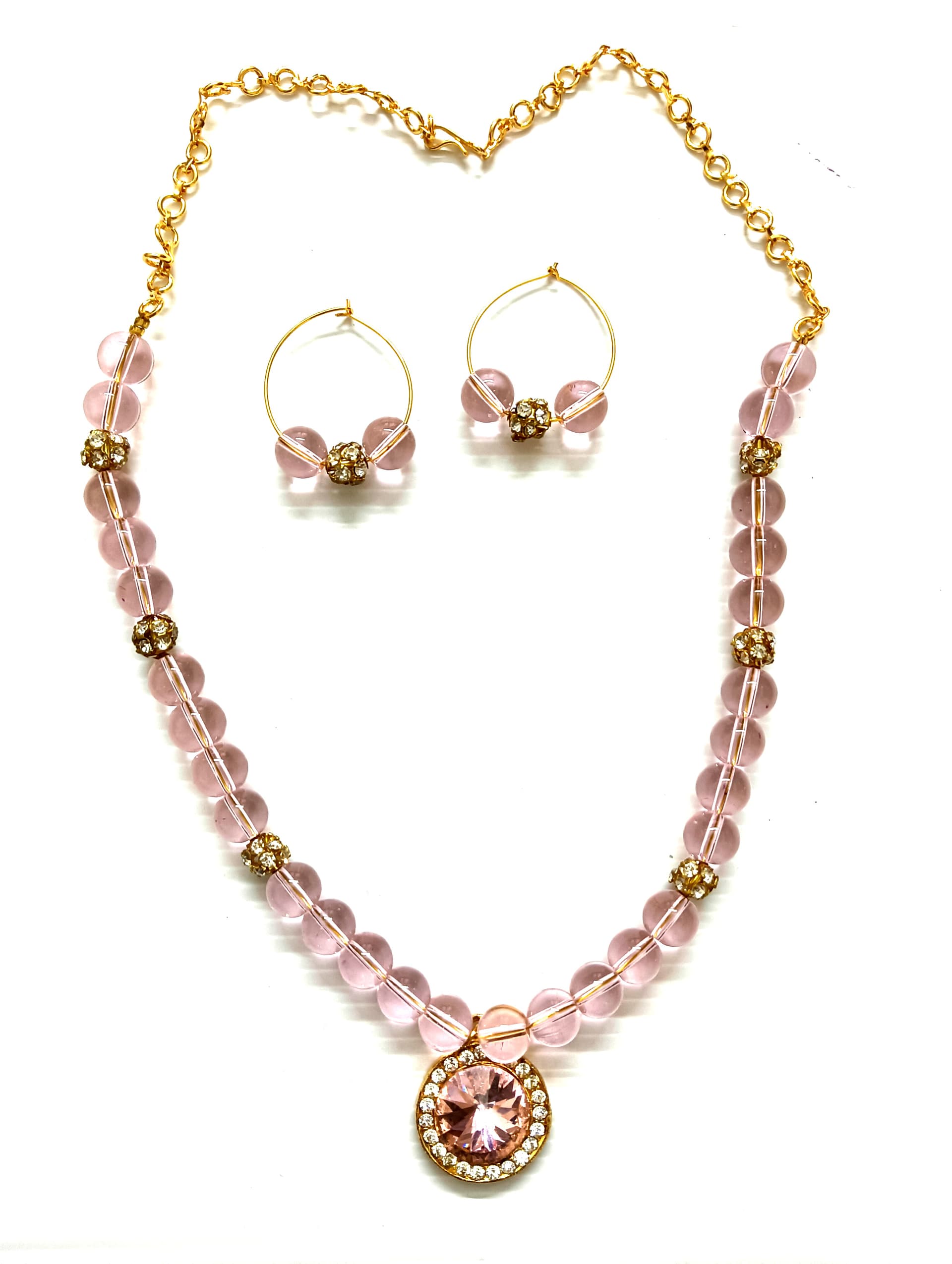 Necklace and earring set — pale pink with a gold medallion