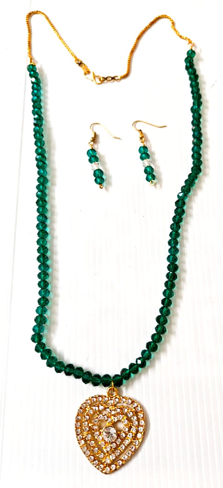 Necklace and earring set — dark green with a brass paisley pendant